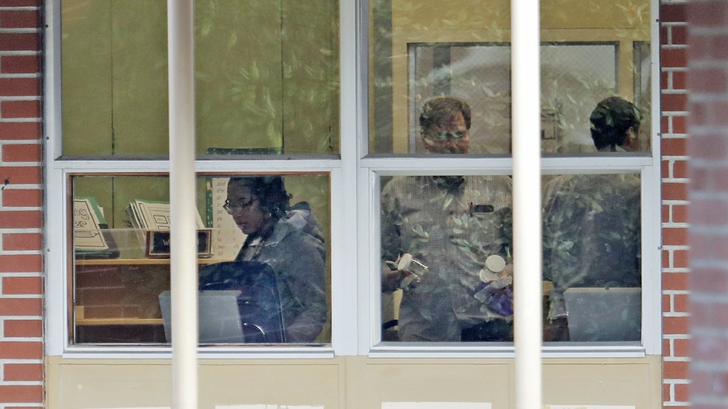 View of toxicology team through school window